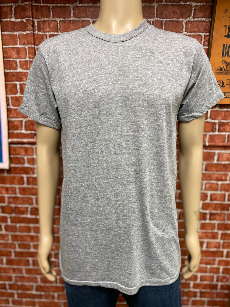 May include: A heather grey t-shirt with short sleeves and a crew neck.