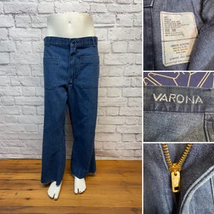 May include: Blue denim pants with large front pockets and a wide leg. The pants are displayed on a mannequin. The label reads "VARONA". The pants have a zipper and a button closure. The size is 30R.