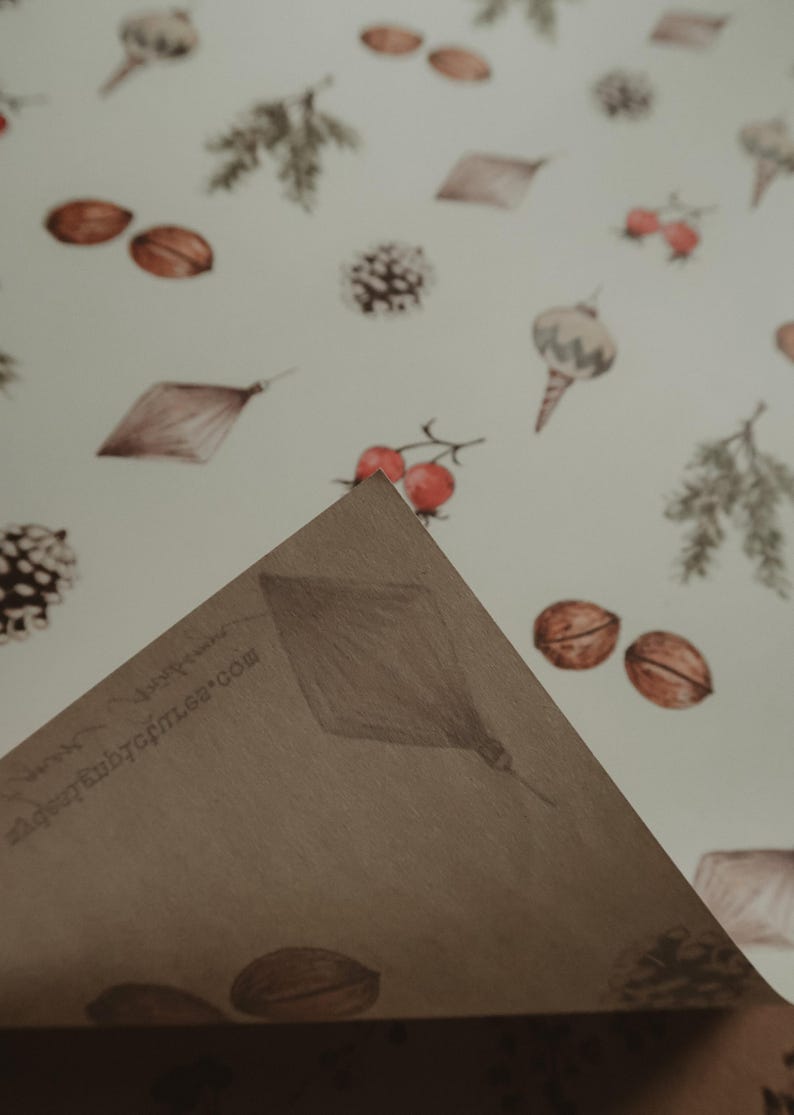 May include: A brown paper gift wrap with a white background and a repeating pattern of pine cones, acorns, berries, and ornaments. The text "www.babybottle.com" is printed on the paper.