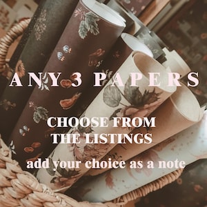 Puede incluir: Una cesta de mimbre contiene varios papeles enrollados con diseños florales y botánicos. Los papeles son en tonos marrón, verde y crema. El texto en la imagen dice: "ANY 3 PAPERS, CHOOSE FROM THE LISTINGS, add your choice as a note."