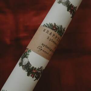 May include: A roll of white wrapping paper with a green and red floral design. The paper is labeled "Wrapping 3 pieces" and "mydesignprints Agneese".