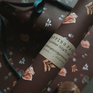 May include: A roll of brown wrapping paper with a white squirrel and floral pattern. The paper is labeled "Wrapping Paper 5 pieces (50x70 cm) ydesignpictures.com".