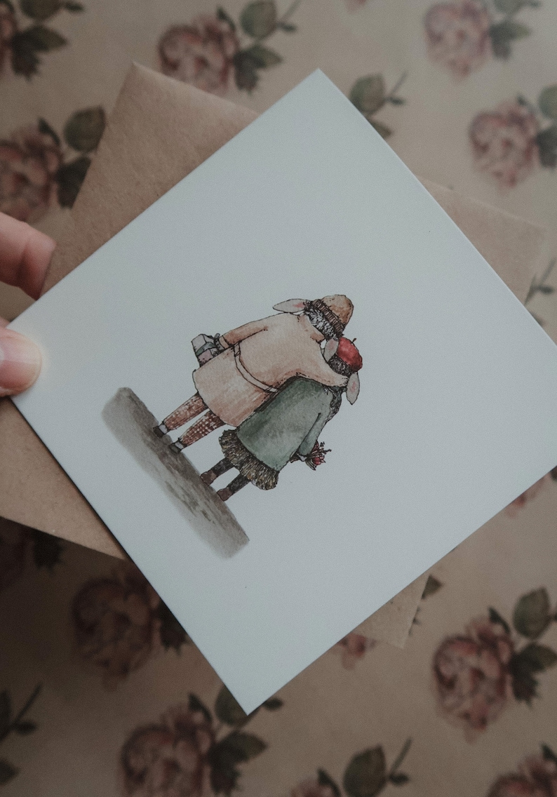 May include: A watercolor illustration of two figures, one wearing a brown coat and a red hat, the other wearing a green coat and a red beret, walking together. The figures are holding hands and appear to be in love.