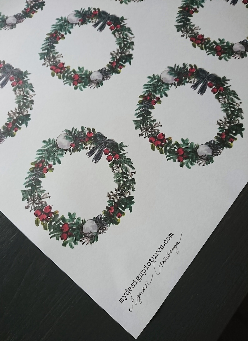 May include: A sheet of white wrapping paper with a repeating pattern of green wreaths with red berries and white ornaments. The paper is signed "mydesignpictures.com Agnes Cr&iacute;nberg&oslash;".