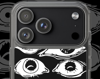 May include: A clear smartphone case featuring a black insert decorated with a repeating pattern of various white graphic eyes. The design includes multiple eye shapes and iris details arranged in rows against a solid black background.