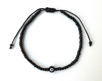 Pulsera de cuentas de semilla de ojo malvado negro: amuleto minimalista de la suerte
