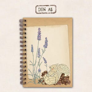 May include: A spiral-bound notebook with a kraft paper cover and a cream-coloured page featuring a lavender illustration and a squirrel made of book pages. The text "DIN A5" is stamped at the top.