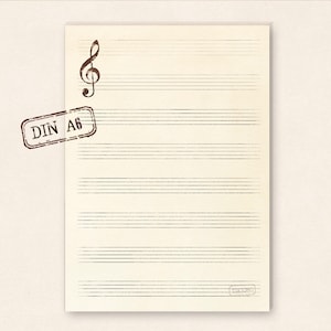 Könnte beinhalten: Ein leeres Blatt Musikpapier mit einem Violinschlüssel oben und einem Stempel mit der Aufschrift "DIN A6" oben links. Das Papier ist mit fünf Linien versehen und hat ein leichtes Wasserzeichen.