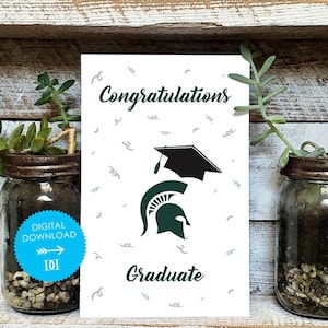 May include: A white graduation card with the words "Congratulations Graduate" in green script. The card features a black graduation cap and a green Spartan helmet logo. The card is decorated with small gray swirls and is a digital download.