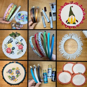 May include: A collection of embroidery hoops with various designs, including floral patterns, a gnome, and a white fringe trim. The hoops are displayed on a wooden surface with paint markers and other crafting supplies.
