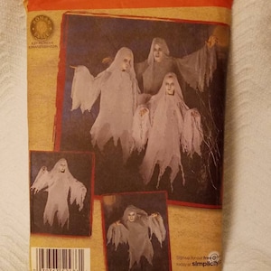 May include: A Simplicity sewing pattern for making ghost costumes. The pattern number is 2486. The pattern includes instructions for making a ghost costume in sizes S-M, M-L. The pattern is for adults and children.