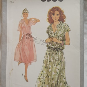 May include: Simplicity sewing pattern number 8588 for a dress. The pattern is for size 10 and is specially marked for adjustments to Miss Petite sizes. The pattern shows two models wearing the dress, one in a pink dress and the other in a green floral dress.