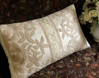 Cream silk pillow with vintage beige embroidered and bobbin laces hand sewn to top.