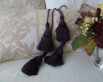 Pair of vintage plum toned tassels. New merchandise from the 90's