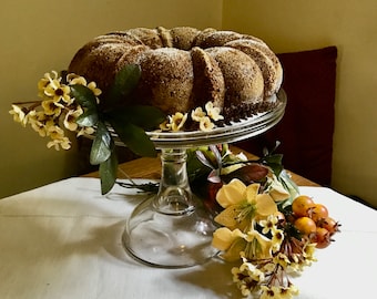 Vintage clear glass cake stand from general store era.