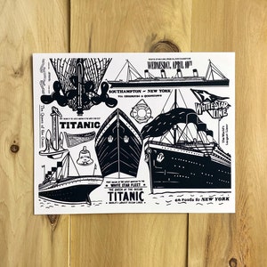 May include: A black and white illustration of the RMS Titanic, the "Queen of the Ocean", with the text "White Star Fleet" and "Titanic" on the image. The image also includes a lifeboat, an anchor, a bell, and a ship's wheel.