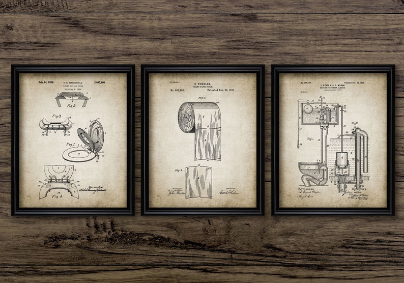 May include: Three vintage patent drawings in black and white, framed in black frames. The drawings depict a toilet seat, a roll of toilet paper, and a toilet flushing mechanism.