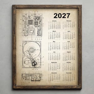 May include: A framed 2027 calendar print on aged paper featuring technical patent-style illustrations of computer hardware components, including a motherboard and a hard drive, with black text detailing the months of the year.