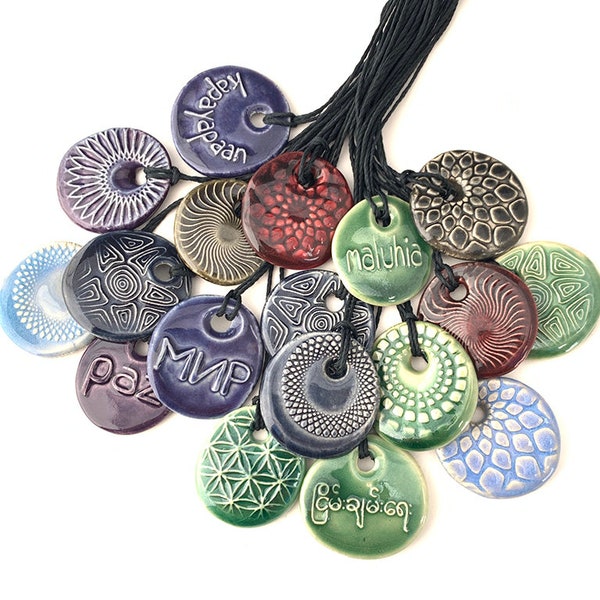 Ceramic pendants with peace in many languages!
