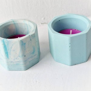 A pair of turquoise jesmonite tealight holders. Octagon candle holder homeware home decor unique concrete style marble swirl pattern