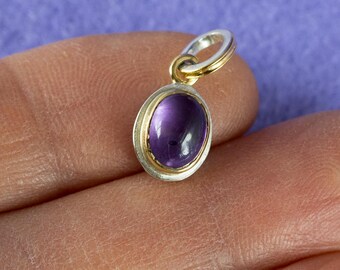 handmade pendant in silver, gold bezel, set with amethyst