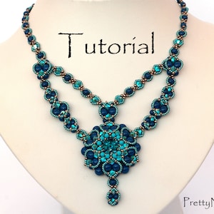 May include: A two-strand necklace with a large, teal and blue beaded pendant. The necklace is made with small, round beads in shades of teal, blue, and copper. The pendant is a flower-shaped design with a teardrop-shaped bead hanging from the bottom. The necklace is on a white mannequin bust. The word "Tutorial" is written in brown text on the bust.