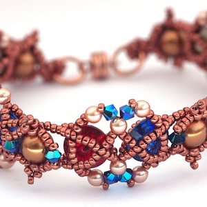May include: A copper wire bracelet featuring red, blue and white beads. The bracelet is crafted with a range of beads, including round, faceted and seed beads.