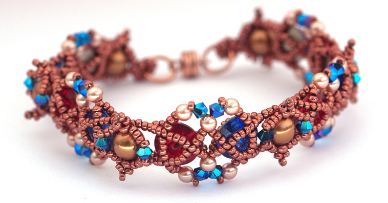 May include: A copper wire bracelet featuring red, blue and white beads. The bracelet is crafted with a range of beads, including round, faceted and seed beads.