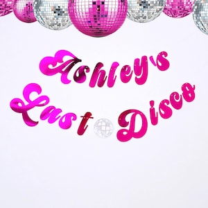 May include: Pink and silver disco ball banner with the text "Ashley's Last Disco".