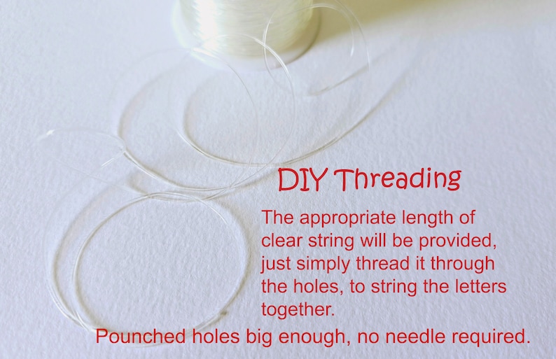 May include: A spool of clear string with a length of string already unwound. The text "DIY Threading" is written in red. The text below reads "The appropriate length of clear string will be provided, just simply thread it through the holes, to string the letters together. Pounched holes big enough, no needle required."