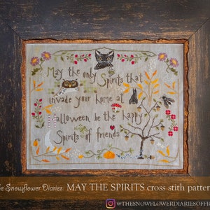 May include: A cross stitch pattern with a vintage aesthetic featuring a black cat, owl, and bat. The text reads "May the only Spirits that invade your home at Halloween be the happy Spirits of friends".