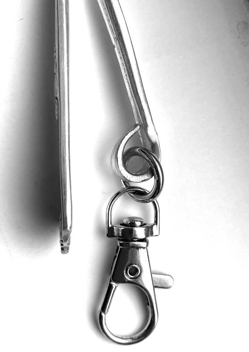 May include: A silver key chain with a swivel clasp and a loop for attaching keys.