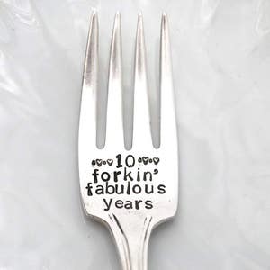May include: Silver fork with the text "10 forkin' fabulous years" engraved on the handle.