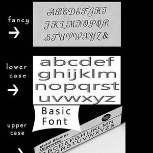 May include: A close-up of a metal stamp set with three different font styles: fancy, lowercase, and uppercase. The stamp set is 6 mm in size and includes all letters of the alphabet and the ampersand symbol.