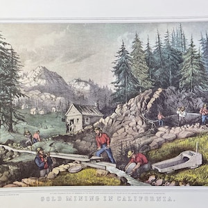 May include: A vintage illustration depicting gold mining in California. The scene shows miners panning for gold in a river, with a small cabin and a rocky hillside in the background. The illustration is in a watercolor style, with a muted color palette.