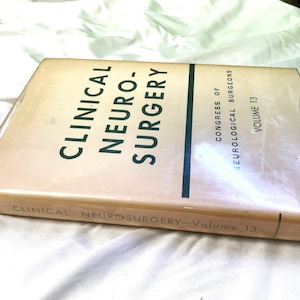 May include: A tan hardcover book titled "Clinical Neuro-Surgery" with the text "Congress of Neurological Surgeons Volume 13" on the spine.