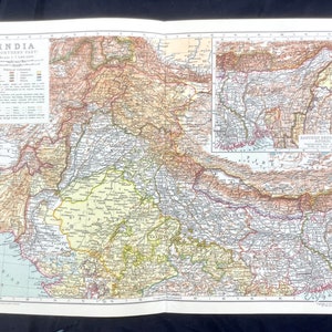 May include: A vintage map of Northern India, showing the political divisions of the region. The map is printed in brown, green, yellow, and red, with a scale of 1:7,500,000. The map includes a smaller inset map of Eastern Nepal and Bhutan.