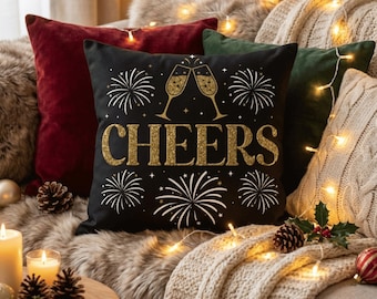 Black holiday pillow cover with gold cheers design and festive fireworks print