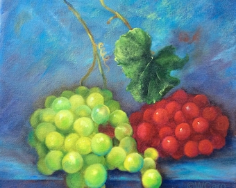 May include: An oil painting of green and red grapes with a green leaf on a blue background. The green grapes are on the left, and the red grapes are on the right. The painting is signed by the artist.