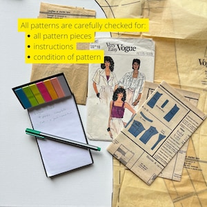 May include: Vintage sewing patterns, including a Vogue pattern, with a notepad, pen, and sticky notes. The text on the notepad reads "Vogue 8662 - 9 pieces - complete - cut - V your condition". The image also includes text that says "All patterns are carefully checked for: all pattern pieces, instructions, condition of pattern."