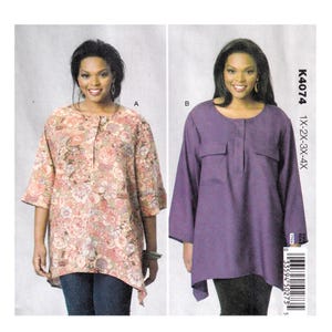 May include: Two women modelling tunic tops. One is a floral print in pinks and peaches, the other is a solid purple with two front pockets. The pattern number is K4074 and the sizes are 1X-2X-3X-4X.