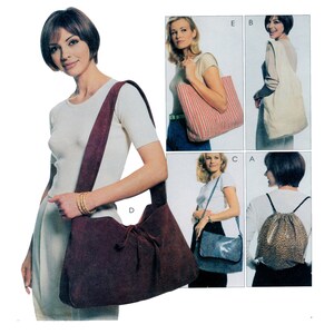 May include: Five different styles of handbags. A brown suede handbag with a drawstring closure, a striped tote bag, a white canvas tote bag, a blue crossbody bag with a geometric pattern, and a leopard print rucksack.