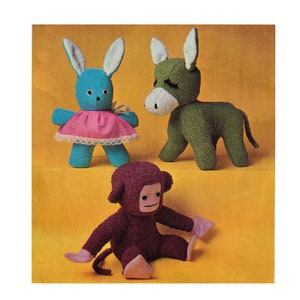 May include: Three handmade stuffed animals: a blue bunny wearing a pink dress, a green donkey, and a maroon monkey. The bunny has long ears and a white bow. The donkey has a white muzzle. The monkey is sitting with its arms outstretched.