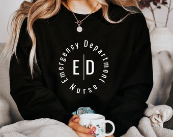 May include: Black sweatshirt with white text that reads "Emergency Department Nurse" in a circle with the letters "ED" in the center.