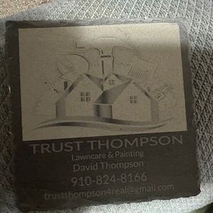 May include: Black slate coaster with a white logo that says "TRUST THOMPSON" and includes the text "Lawncare & Painting", "David Thompson", "910-824-8166", and "trustthompson4real@gmail.com".