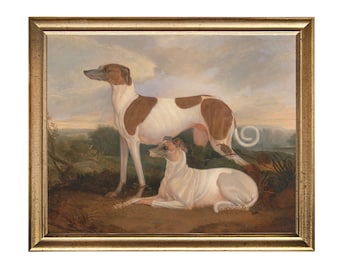 May include: A framed oil painting depicting two white and brown greyhounds. The dogs are standing and lying down in a grassy field with a cloudy sky in the background.