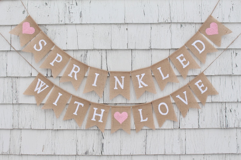 May include: A burlap banner with pink hearts and the text "SPRINKLED WITH LOVE" in white letters.