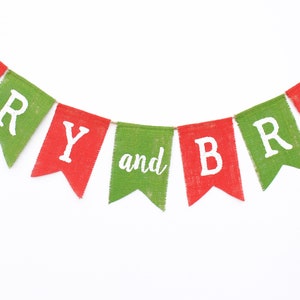 May include: A festive banner with alternating red and green pennants. Each pennant displays white lettering spelling out "MERRY and BRIGHT". The banner is made of a textured material, perfect for holiday decorations.