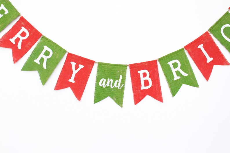 May include: A festive banner with alternating red and green pennants. Each pennant displays white lettering spelling out "MERRY and BRIGHT". The banner is made of a textured material, perfect for holiday decorations.