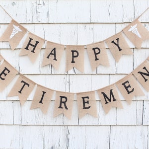 May include: A burlap banner with the words "Happy Retirement" in black lettering. The banner is strung with twine and has a small white medical symbol on each end.